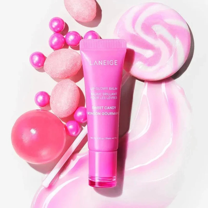 Laneige Lip Glowy Balm in Sweet Candy, a pink hydrating lip tube surrounded by candies and a glossy texture swatch.
