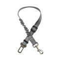 Adjustable grey reflective dog car seat belt with elastic shock-absorbing tether for safe pet travel.