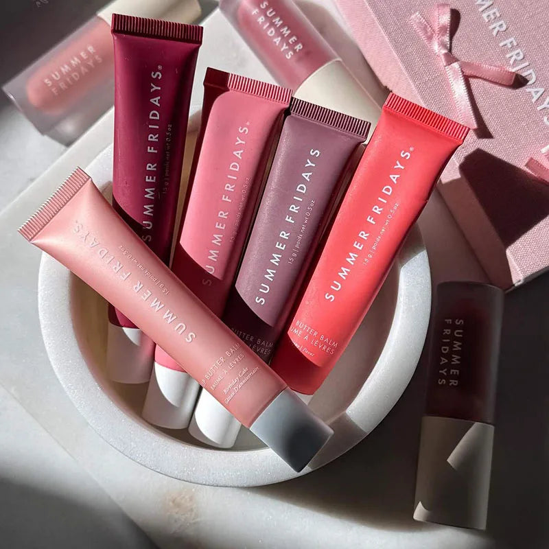 Summer Fridays lip butter balm set in diverse pink and beige shades with smooth, moisturizing formulas in soft tubes.