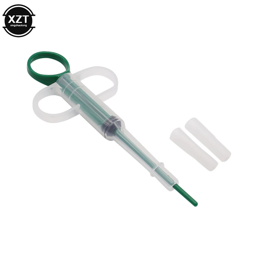Green plastic pet pill dispenser and medicine syringe for easy tablet or liquid feeding for dogs and cats.