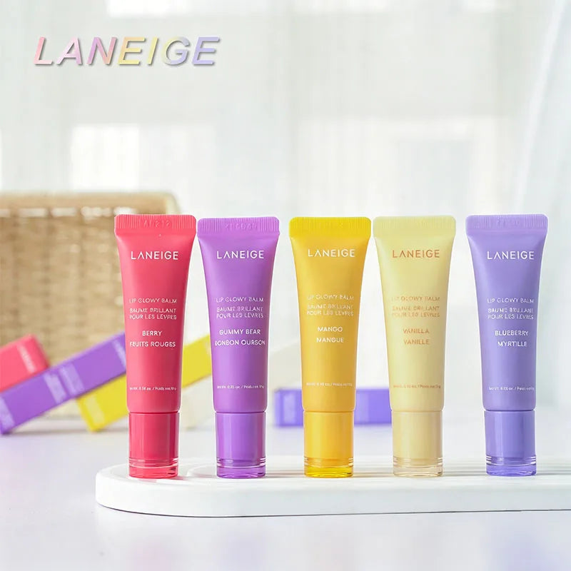 Laneige Lip Glowy Balm set in five colorful tubes: Berry, Gummy Bear, Mango, Vanilla, and Blueberry lip treatments.