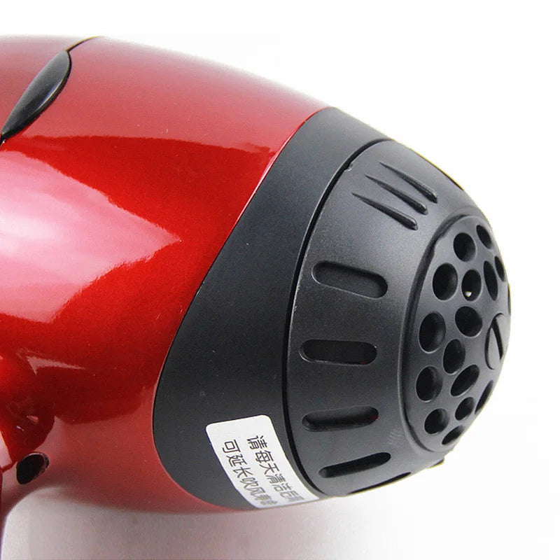 Close-up of a glossy red professional 2300W salon hair dryer with a durable black air intake filter and vented design.