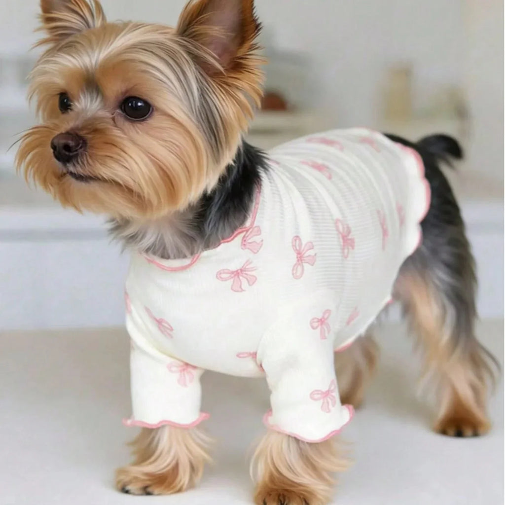 Yorkie wearing a breathable, stretchy white knit dog shirt with a cute pink bow tie print for comfortable everyday wear.
