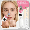 White and pink electric blackhead suction tool with multiple nozzle attachments for facial pore cleansing.
