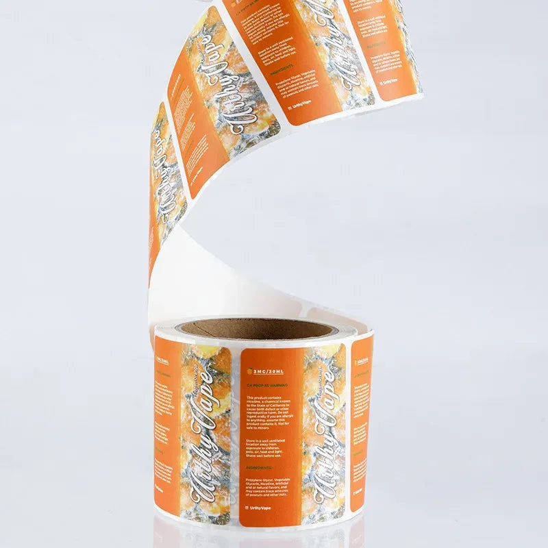 Roll of orange printed adhesive labels with barcode and product text, curled on core.
