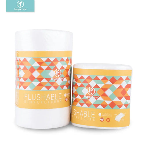 Happy Flute flushable baby diaper liners, 100-count rolls with geometric pattern packaging. Biodegradable baby care.