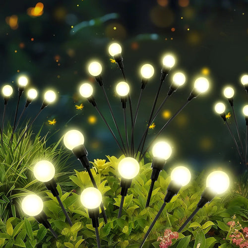 Solar firefly pathway lights with warm glowing round bulbs on flexible black wire stakes