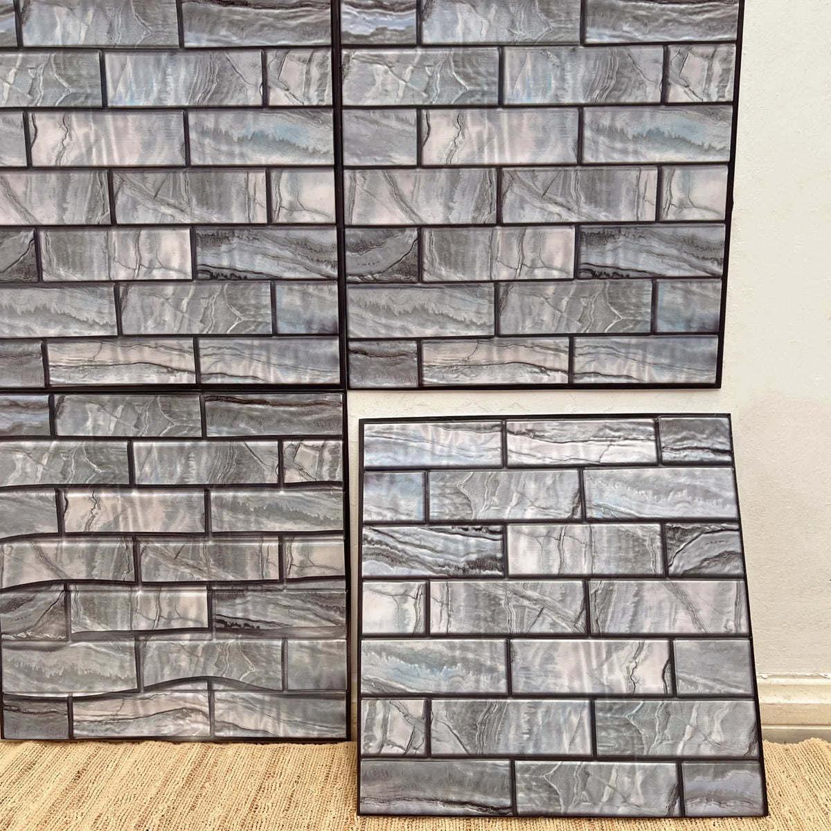 Peel-and-stick backsplash tile sheet with faux brick pattern in cool gray and white