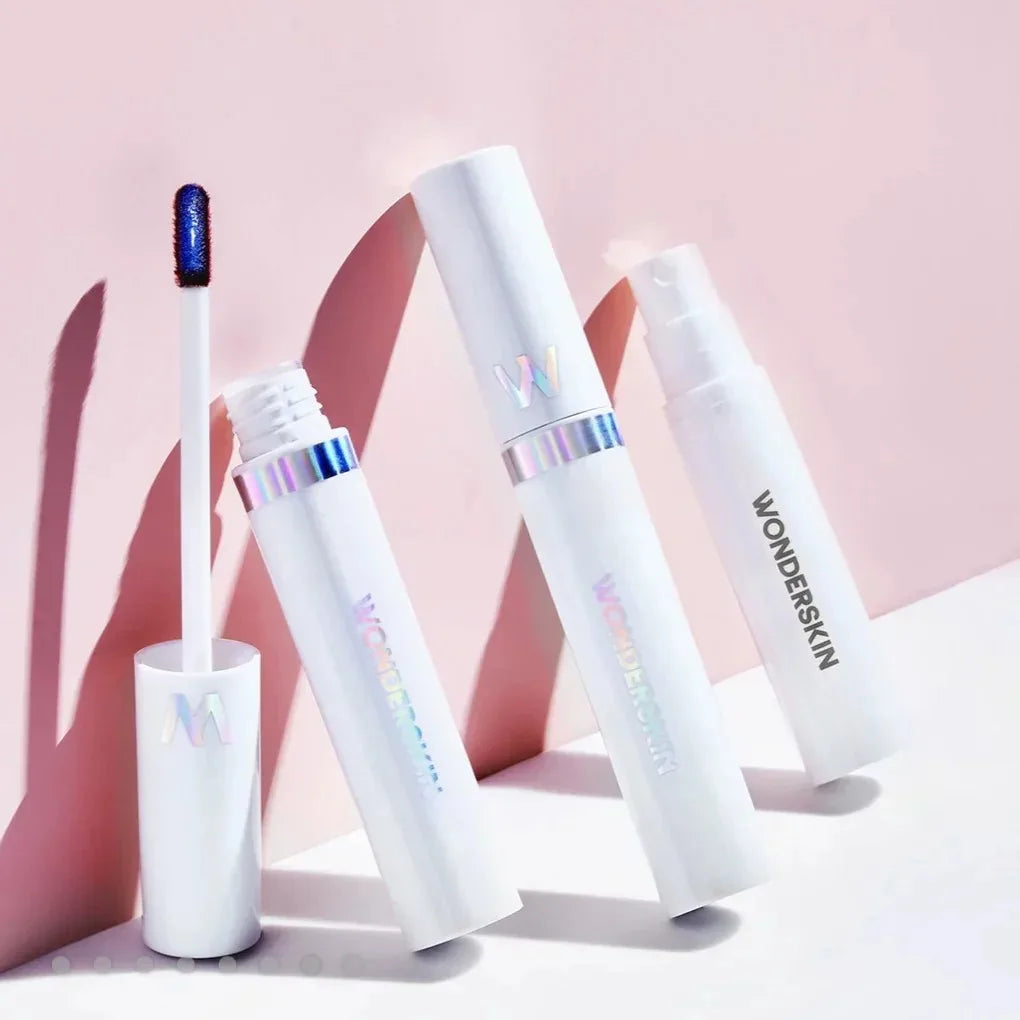 Wonderskin waterproof peel-off lip stain kit with white tubes and blue tinted applicator on a soft pink background.
