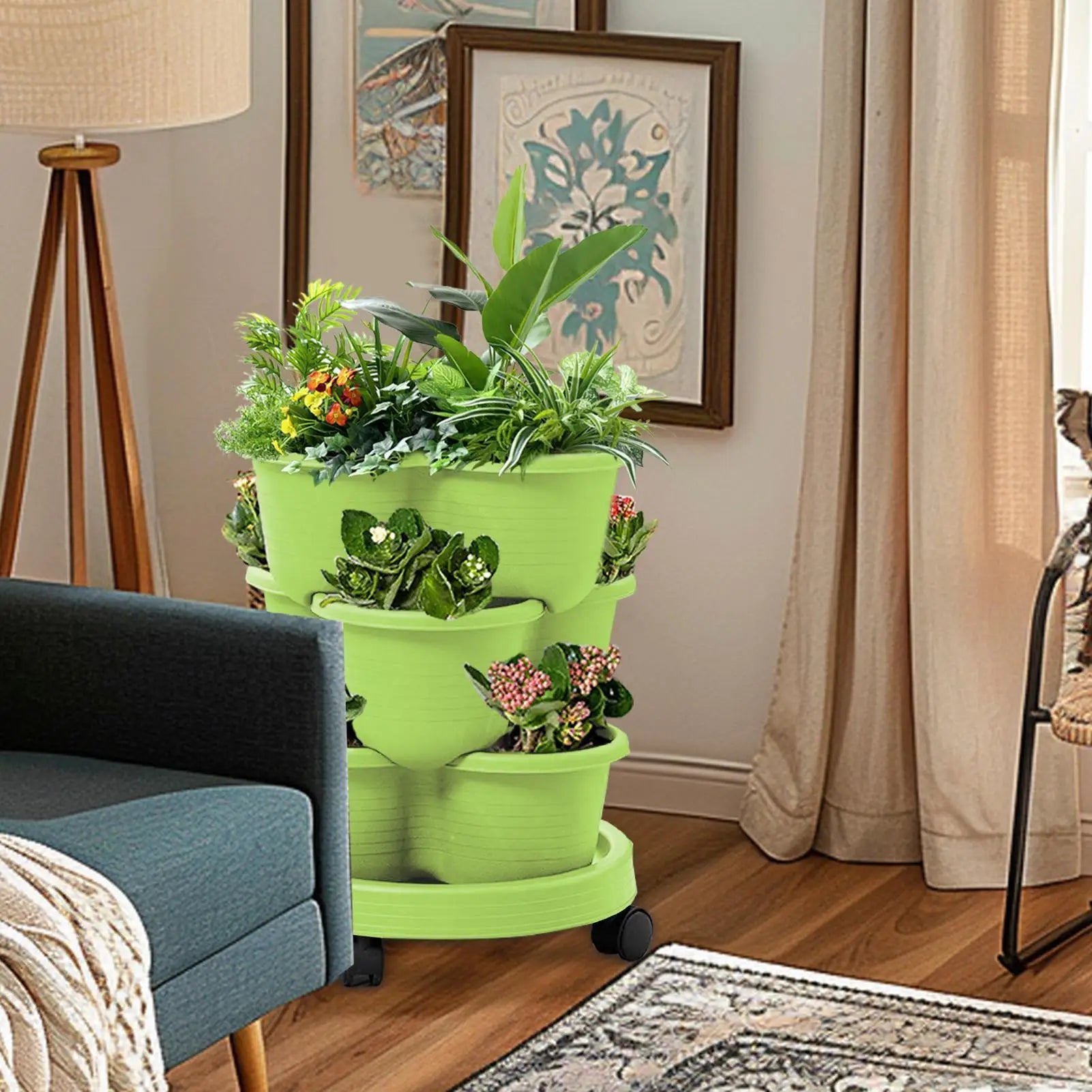 Light green stackable tiered planter tower with three pots on rolling wheels base.