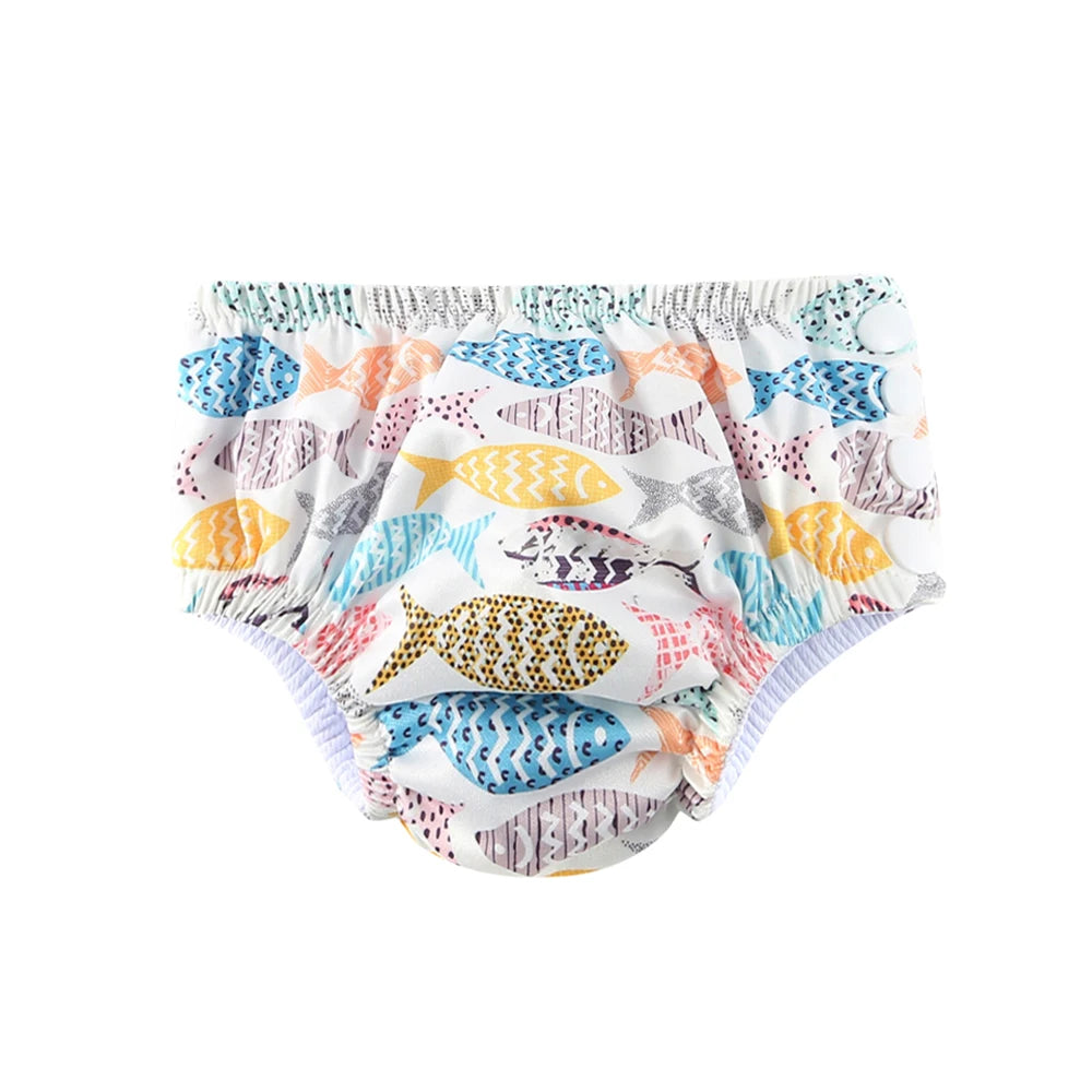 Reusable baby swim diaper with colorful fish print and snap closures for adjustable fit.