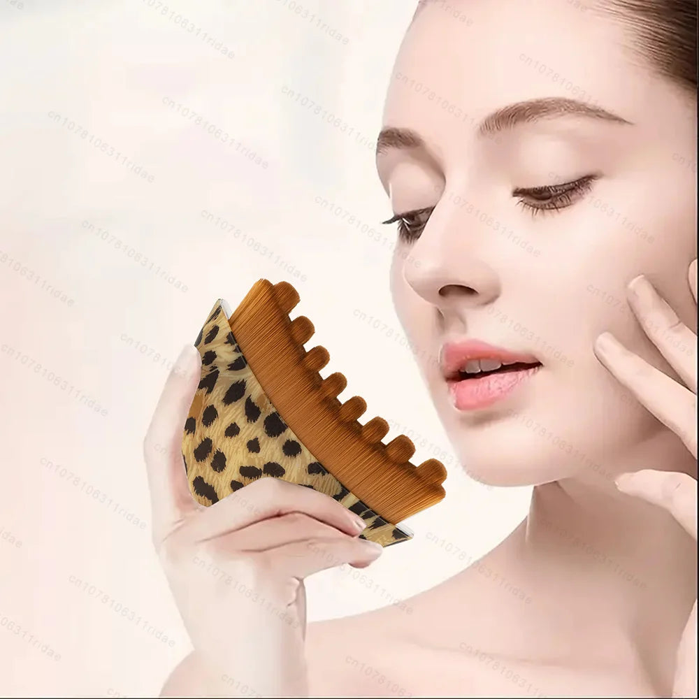 Woman holding a leopard-print gua sha facial brush with brown bristles, designed for lymphatic drainage massage.