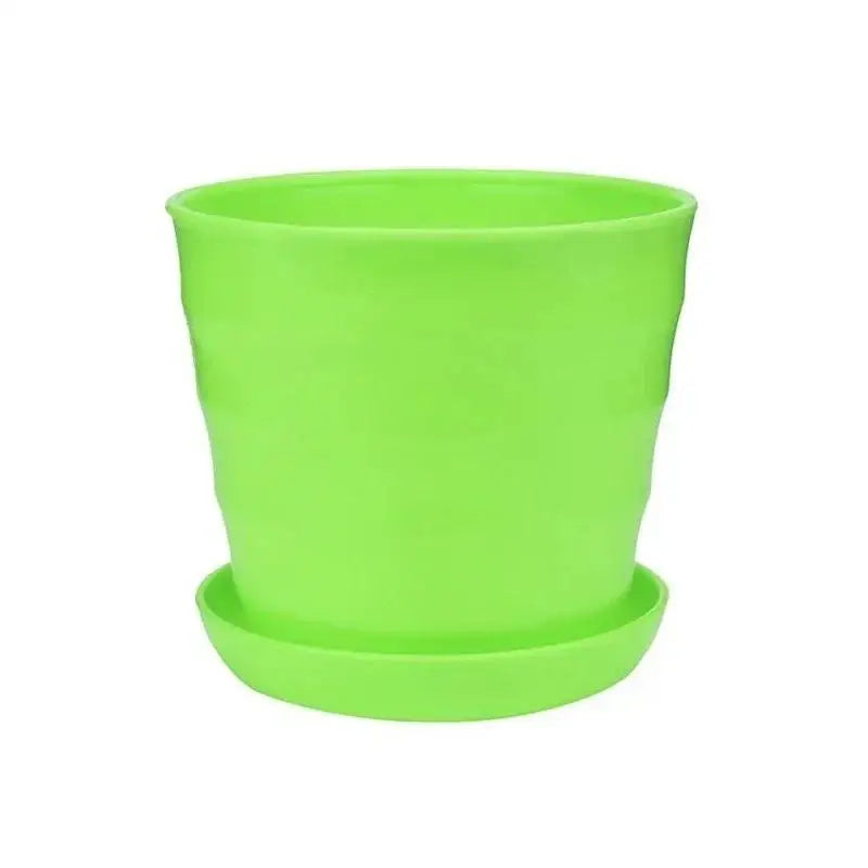 Green plastic flower pot with matching saucer, simple straight-sided design
