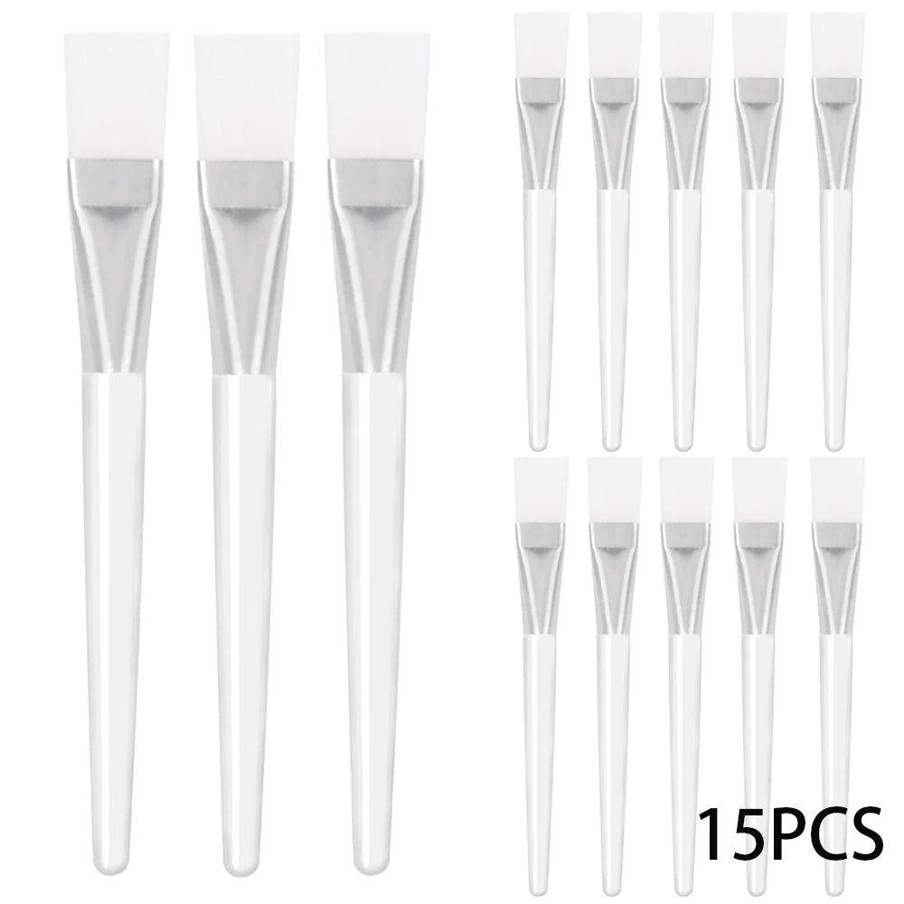 A set of 15 facial mask applicator brushes with white silicone heads, silver ferrules, and clear plastic handles.