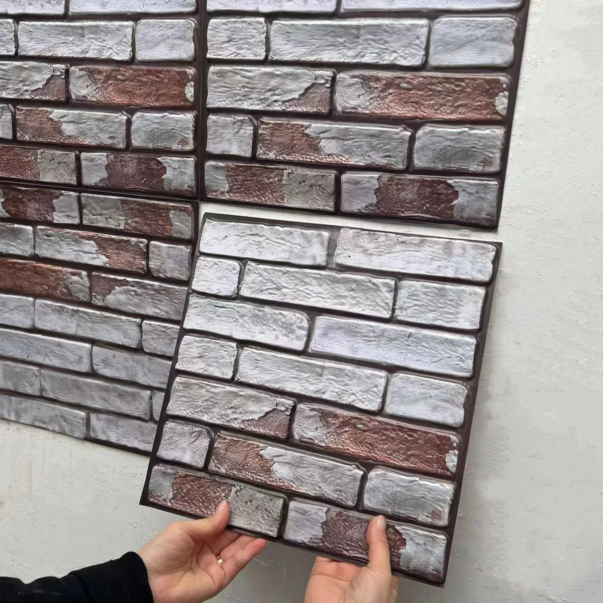 Peel-and-stick brick-style backsplash tiles close-up in white and maroon