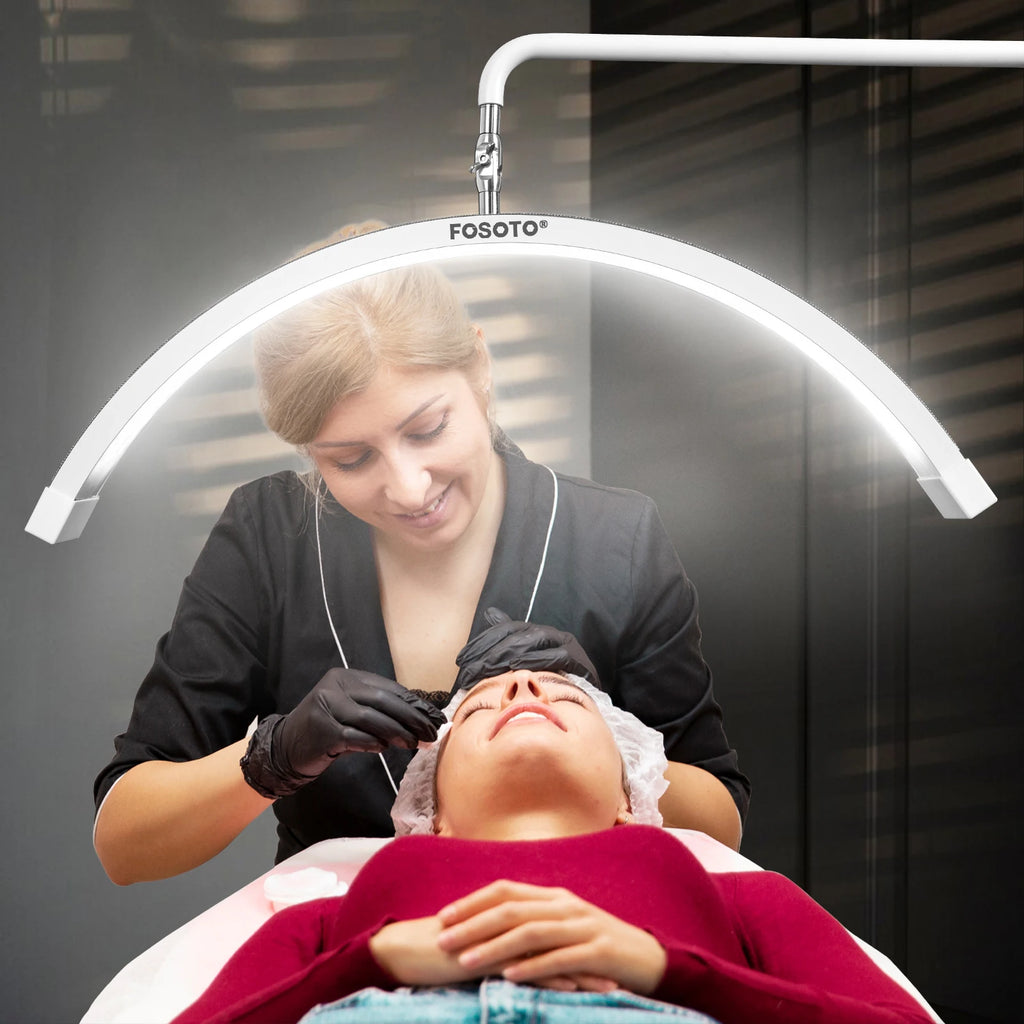 White arc-shaped LED esthetician lamp mounted on an adjustable arm, used for facial treatments and beauty procedures.