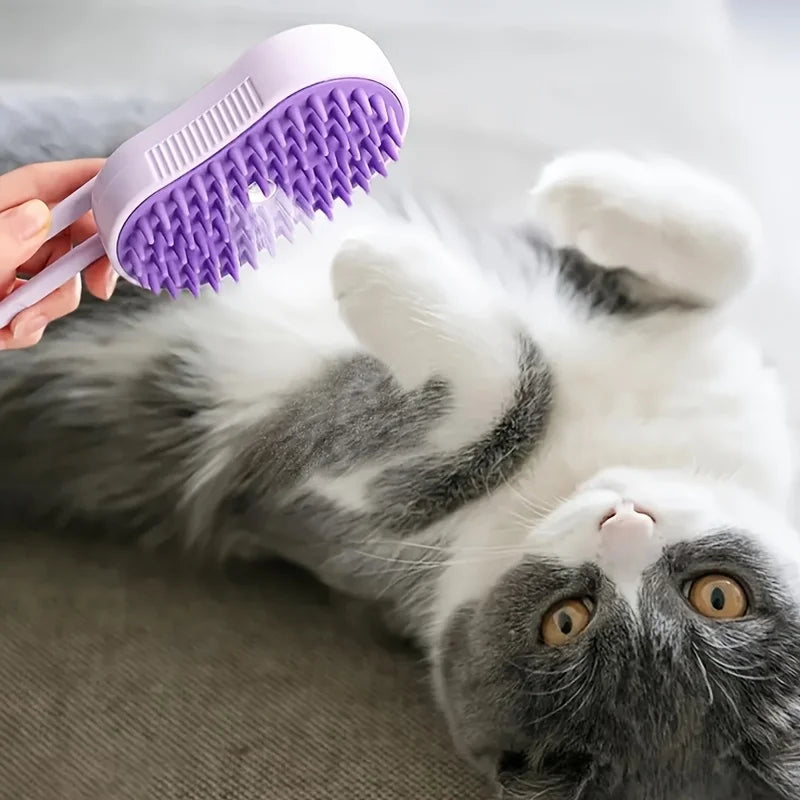 Purple 3-in-1 steam pet brush with silicone bristles grooming a grey and white cat for easy shedding and massage.