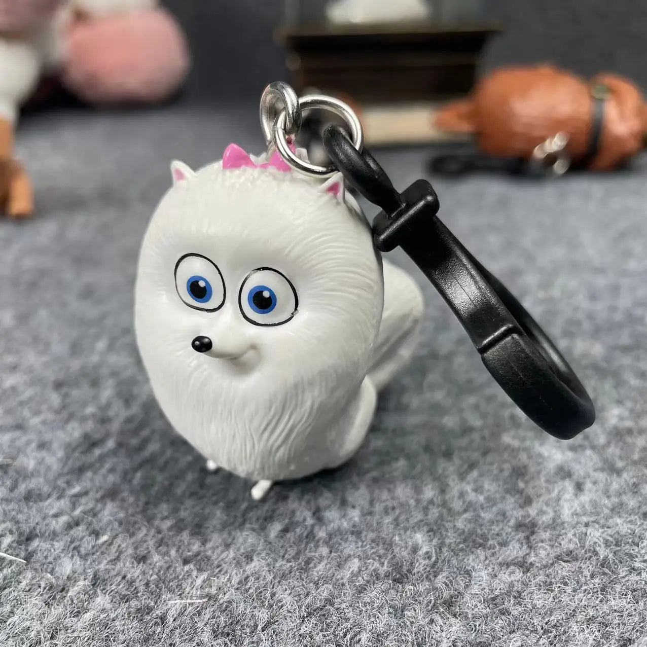 Cute white Gidget pet movie keychain figurine, ideal collectible toy or decorative gift for animal lovers.