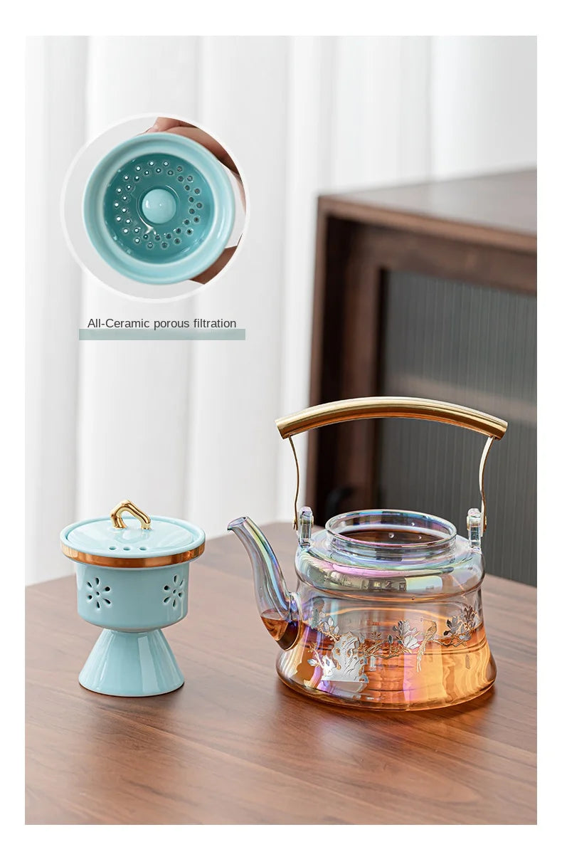Iridescent glass teapot with gold handle and floral ceramic tea infuser featuring all-ceramic porous filtration.