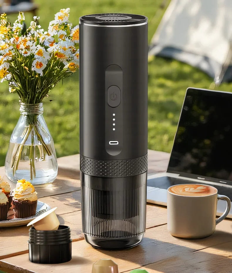 Portable matte black electric espresso maker with USB-C charging and clear reservoir for camping or office use.