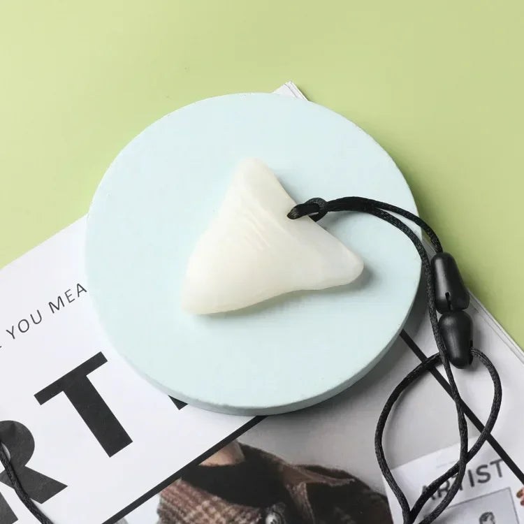 White silicone triangle baby teething toy for sensory and teething relief.