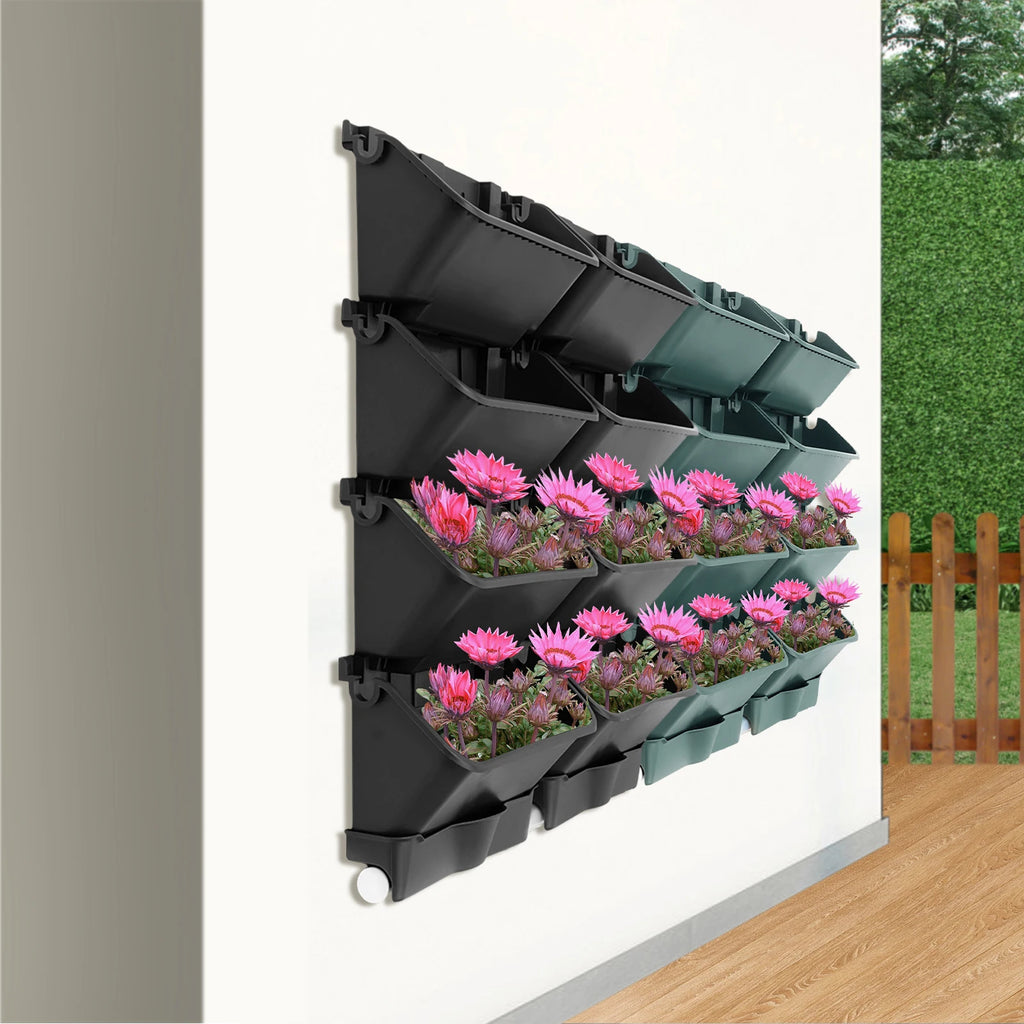 Wall-mounted vertical planter set with pink flowers in black and green rectangular planters