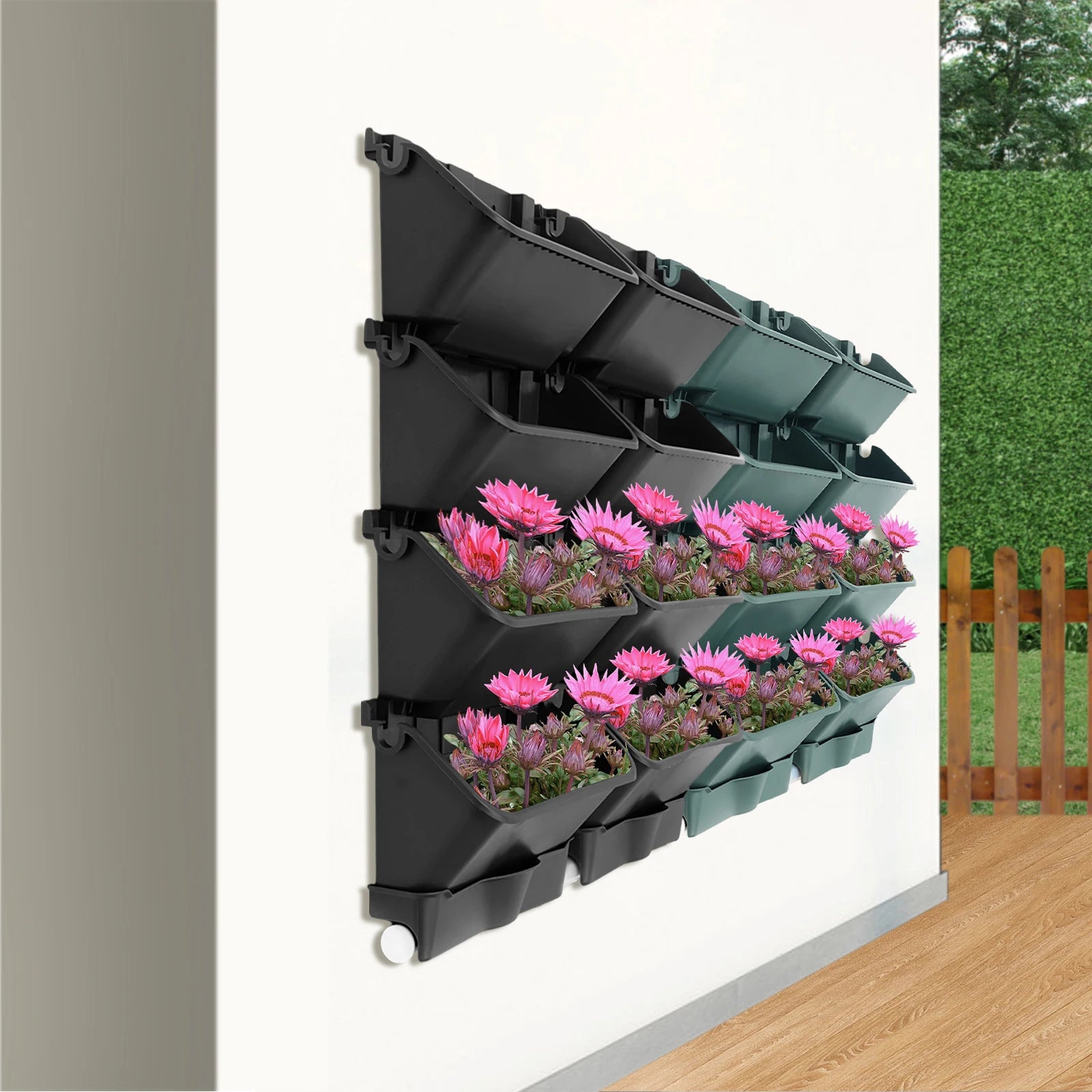 Wall-mounted vertical planter set with pink flowers in black and green rectangular planters
