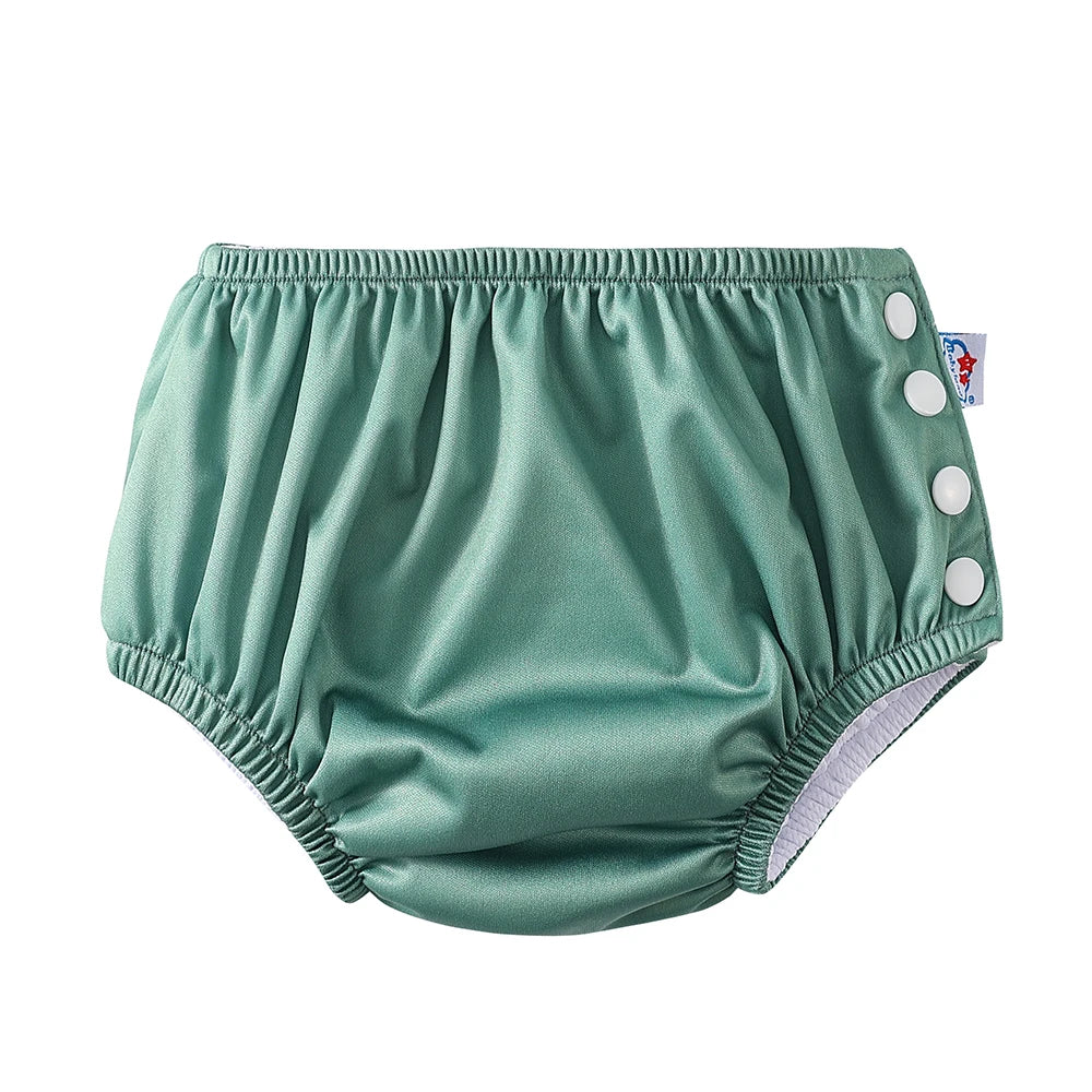 Sage green reusable baby swim diaper with white side snap closures for adjustable fit.