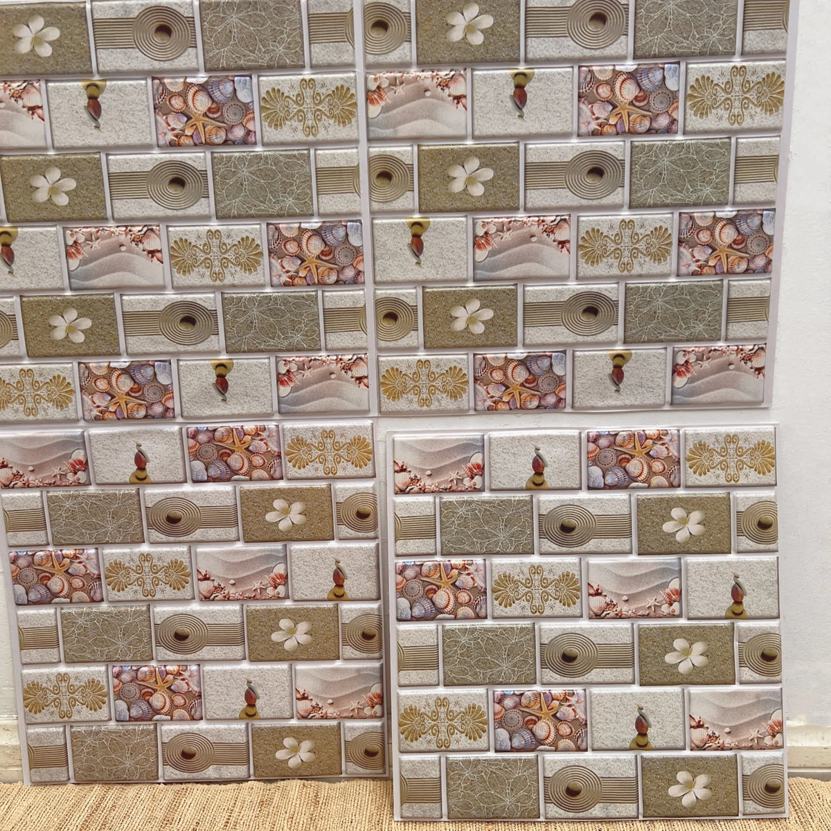 Peel-and-stick backsplash tiles with cream, gold, and floral decorative patchwork design