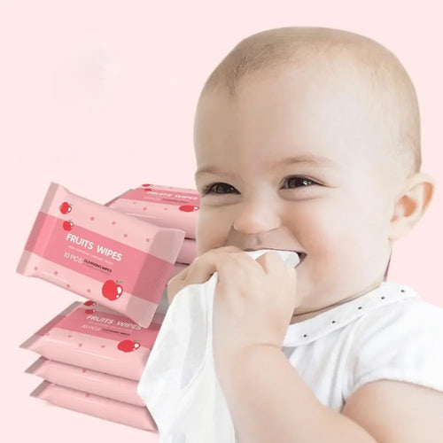 Baby holding Fruits Wipes cleansing tissues in pink apple-print packaging, 10-count baby care wipes.