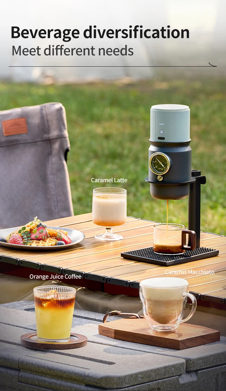 Portable matte blue and black espresso maker on outdoor camping table with coffee drinks and waffles.