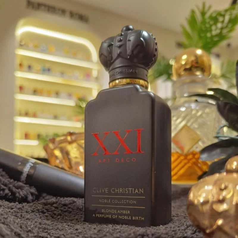 Matte black bottle of Clive Christian XXI Art Deco perfume with a crown cap, red lettering, and gold neck detail.