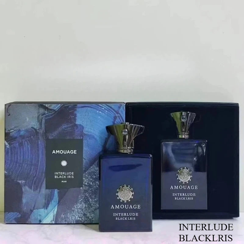 Interlude Black Iris Man perfume set with dark blue glass bottles, metallic caps, and a patterned presentation box.