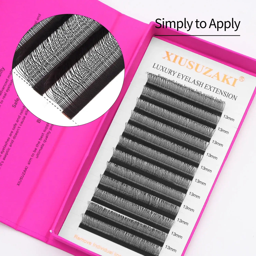 Black synthetic eyelash extension strips in 13mm length, arranged in a pink storage case for professional application.