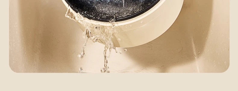 White electric cooking pot with water splashing from the opening