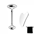 Polished stainless steel facial roller and heart-shaped gua sha tool with a black storage pouch on a white background.