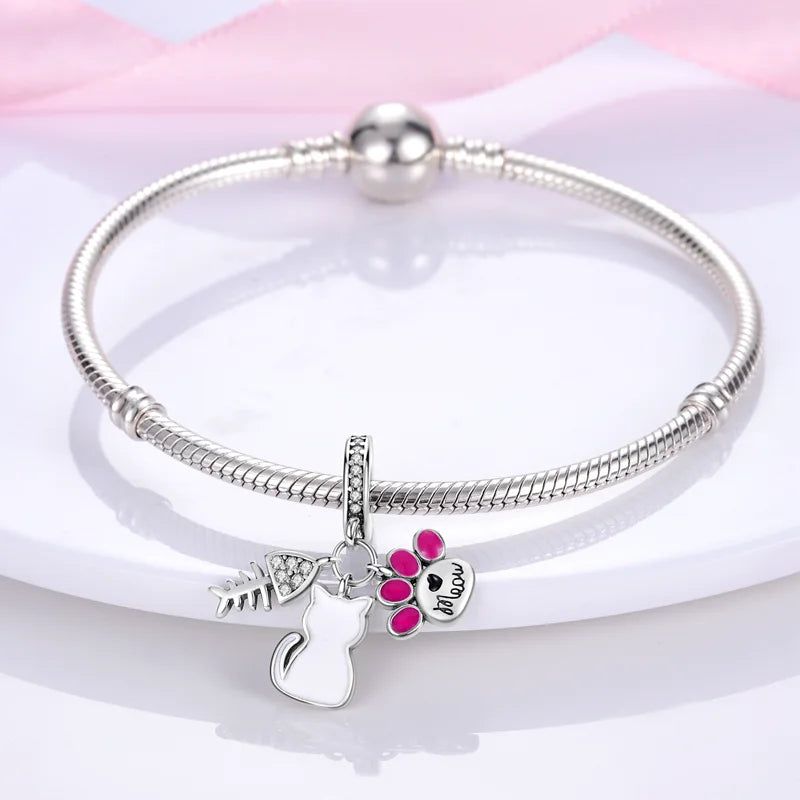 925 sterling silver cat and paw charm bracelet. Cute DIY pet jewelry accessory with fish bone and pink enamel paw.