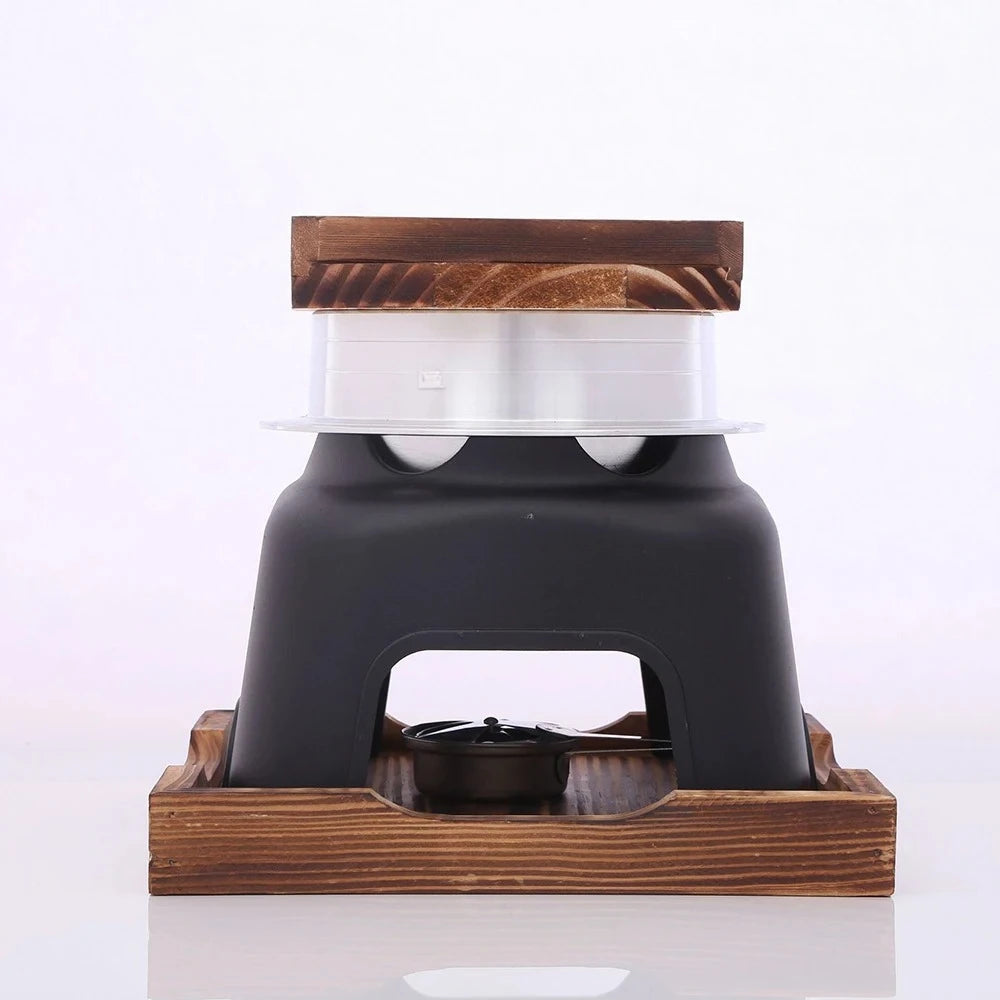 Portable smart multi-cooker front view with black housing, metal inner cup, wood top plate