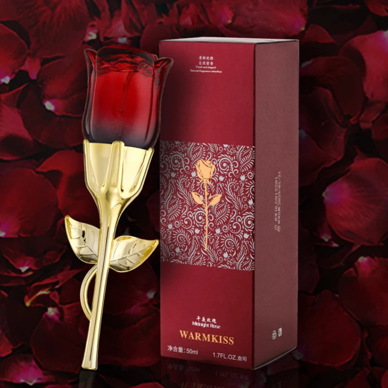 Midnight Rose perfume in a red glass rose-shaped bottle with a gold stem, next to a matching dark red gift box.