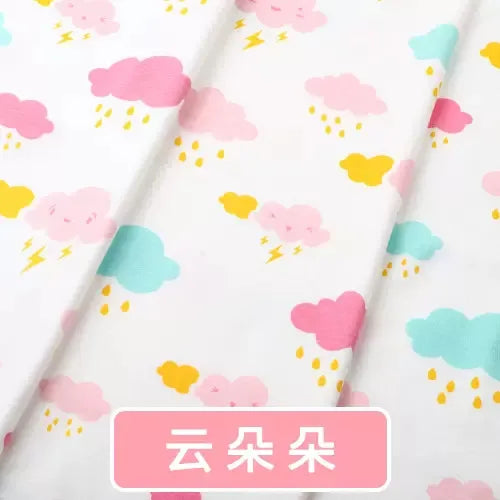 Tidesmit white knit jersey fabric featuring a colorful print of pink and blue clouds with yellow rain and lightning.