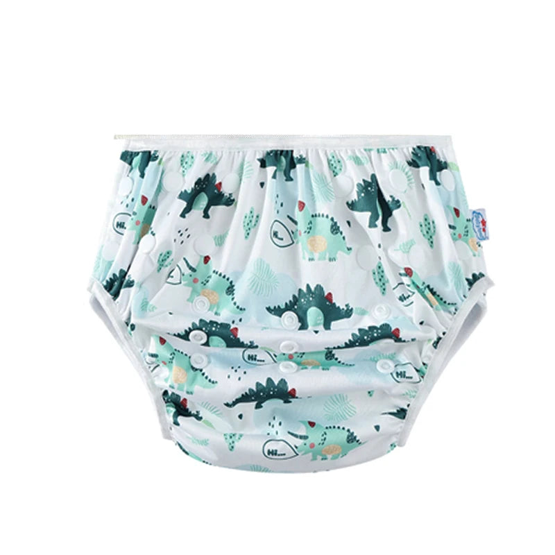 Reusable baby diaper with adjustable snaps and cute green dinosaur pattern for baby care.