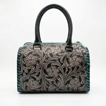 Genuine leather mini duffel trunk with floral embossed design, teal accents, and black double handles.