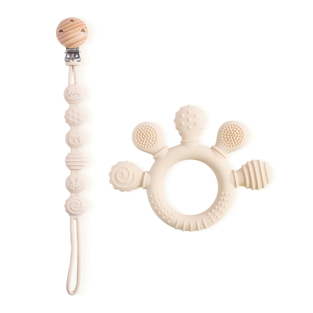 Beige silicone baby teething ring and pacifier clip for soothing sore gums.