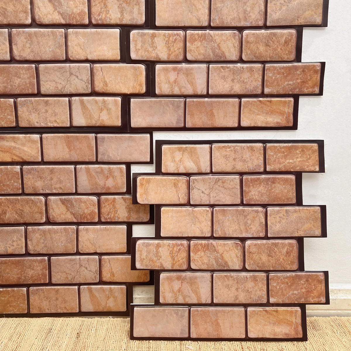 Peel-and-stick backsplash tile sheet with beige-brown stone brick pattern
