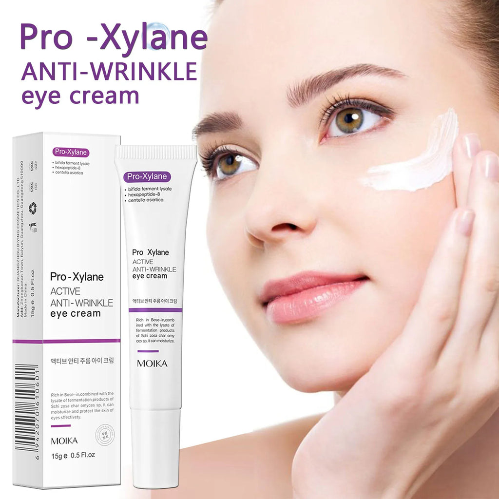 Pro-Xylane anti-wrinkle eye cream in a white tube with smooth, creamy texture applied to face for dark circles.