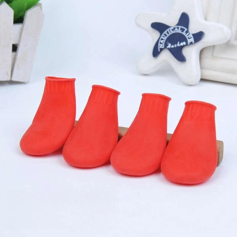 4 red waterproof rubber dog boots for paw protection. Durable, anti-slip shoes for small to large dogs. 4-pack set.