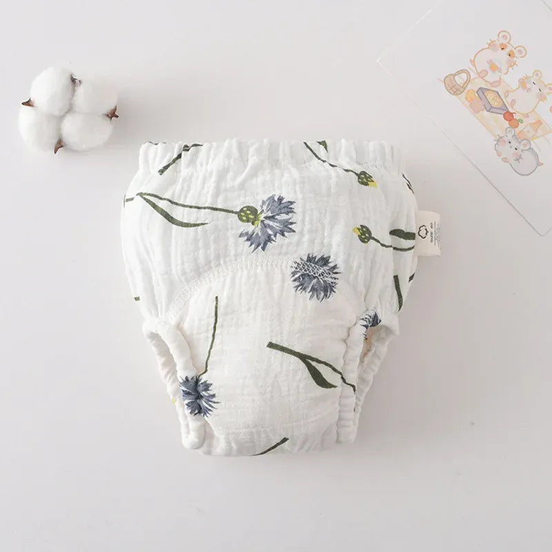 White baby training diaper with blue cornflower floral print. Soft reusable cotton baby care diaper for potty training.