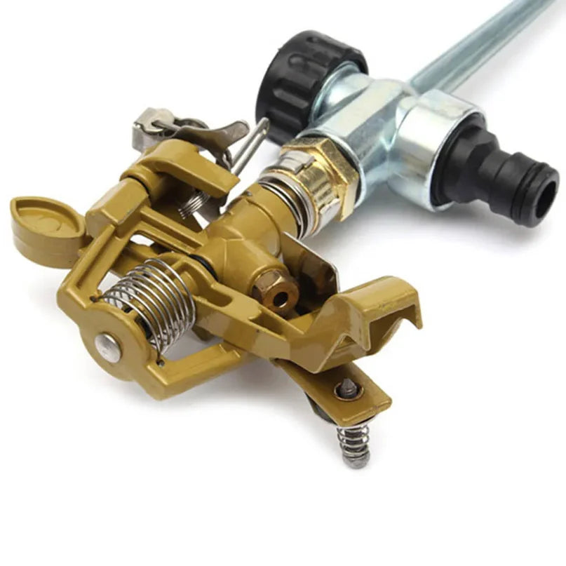 Garden sprinkler head with gold metal body, silver parts, and black hose connector