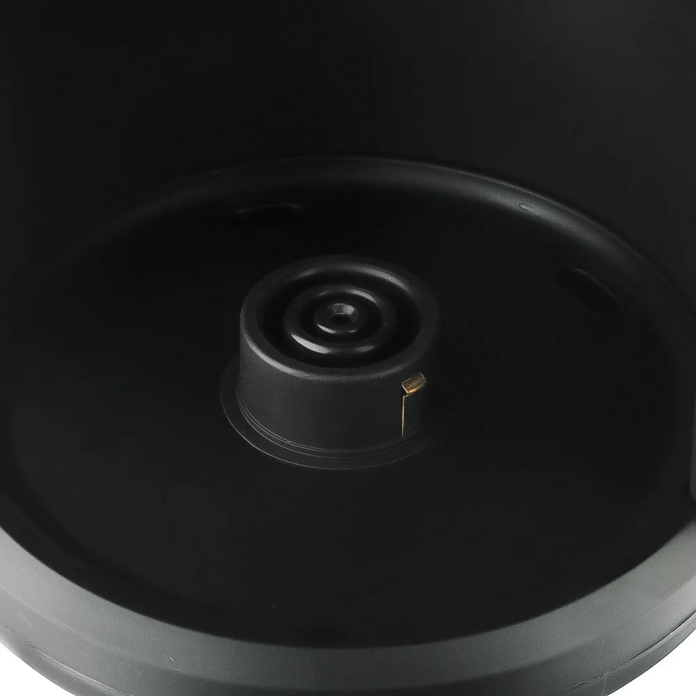 Close-up of a black matte plastic electric kettle heating base with a central contact pin for cordless operation.