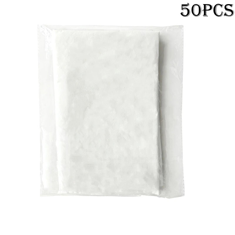 Tidesmit pack of 50 white rectangular nonwoven disposable massage face cradle covers in clear plastic packaging.